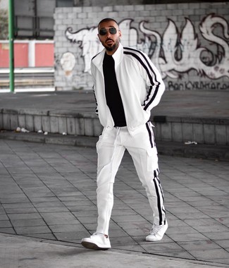 White Track Suit Outfits For Men: Combining a white track suit with a black crew-neck t-shirt is a nice choice for a casual but sharp ensemble. Introduce white leather low top sneakers to this ensemble for an added touch of style.