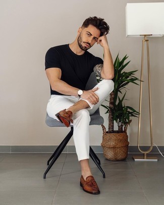 Brown Leather Tassel Loafers Outfits: Effortlessly blurring the line between sharp and casual, this combo of a black crew-neck t-shirt and white chinos is bound to become your favorite. Why not add brown leather tassel loafers to this getup for an added dose of refinement?