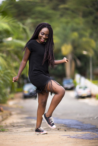 Black Canvas Low Top Sneakers Outfits For Women: Want to infuse your wardrobe with some edgy style? Wear a black fringe casual dress. This ensemble is finished off really well with a pair of black canvas low top sneakers.