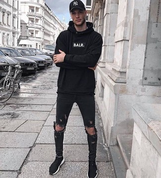 Black Hoodie Outfits For Men: Team a black hoodie with black ripped skinny jeans for a casual ensemble with a fashionable spin. Complement this ensemble with a pair of black athletic shoes to pull the whole thing together.