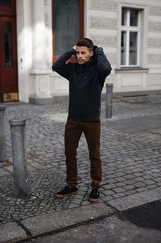 Brown Corduroy Chinos Outfits In Their 20s: A black hoodie and brown corduroy chinos are among those game-changing menswear elements that can refresh your wardrobe. Now all you need is a pair of black and white canvas low top sneakers to finish your look. Wondering how to perfect casual style as you navigate your 20s? This combination is the perfect answer.