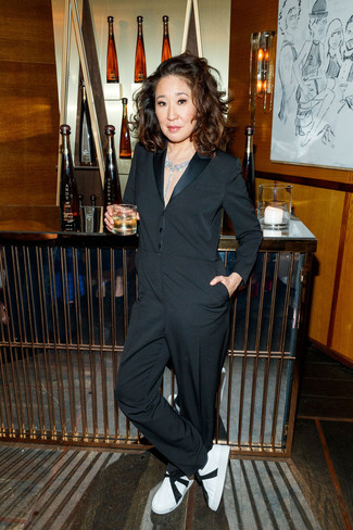 Sandra Oh wearing Black Jumpsuit, White and Black Leather Low Top Sneakers, Clear Necklace
