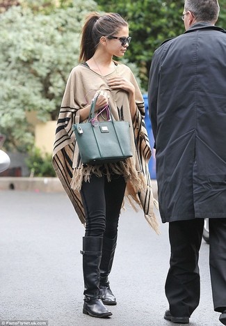 Selena Gomez wearing Dark Green Leather Tote Bag, Black Leather Knee High Boots, Black Leggings, Tan Poncho