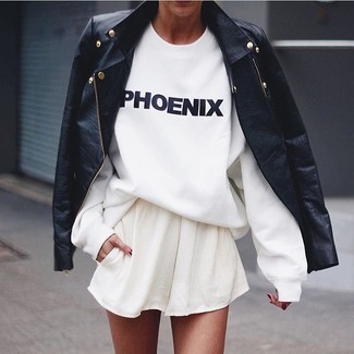 White Skater Skirt Outfits: Showcase your sartorial sensibilities in this relaxed combo of a black leather biker jacket and a white skater skirt.