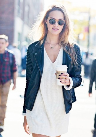 White Sweater Dress Outfits: Nail the effortlessly chic ensemble in a white sweater dress and a black leather biker jacket.