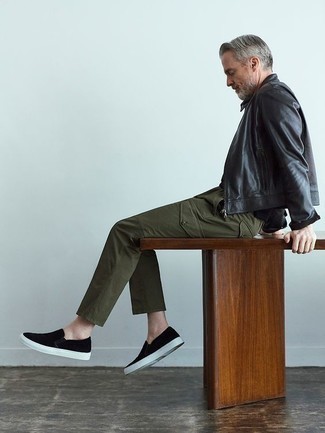 Slip-on Sneakers Outfits For Men: For a laid-back menswear style with a clear fashion twist, you can easily rock a black leather bomber jacket and olive cargo pants. Let your sartorial chops truly shine by complementing this ensemble with slip-on sneakers.