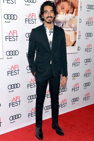 Dev Patel wearing Black Leather Chelsea Boots, White and Black Print Long Sleeve Shirt, Black Suit