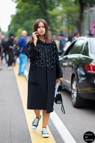Miroslava Duma wearing Black Leather Satchel Bag, Black and White Low Top Sneakers, Black Embellished Coat