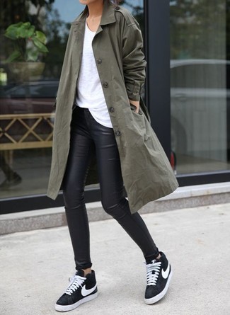 Women's Black and White Low Top Sneakers, Black Leather Leggings, White Crew-neck T-shirt, Dark Green Trenchcoat