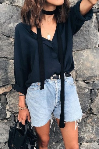 Black Long Sleeve Blouse Outfits: Showcase your sartorial expertise by pairing a black long sleeve blouse and light blue denim shorts for a laid-back getup.