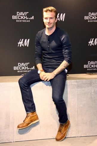 David Beckham wearing Black Long Sleeve Henley Shirt, Navy Jeans, Tan Leather Casual Boots, Brown Leather Watch