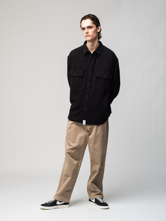 Black Long Sleeve Shirt Outfits For Men: Try pairing a black long sleeve shirt with khaki chinos to create an everyday outfit that's full of style and character. For times when this getup is too much, dial it down by wearing a pair of black and white leather low top sneakers.