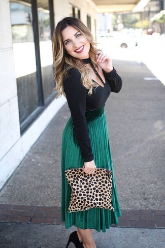 Black Suede Pumps Outfits: A black cutout long sleeve t-shirt and a green pleated midi skirt make for the perfect base for an outfit. A pair of black suede pumps easily kicks up the wow factor of this getup.