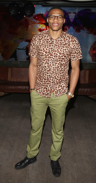 Russell Westbrook wearing Gold Watch, Black Studded Leather Low Top Sneakers, Olive Chinos, Tan Leopard Short Sleeve Shirt