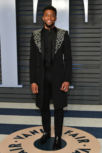Chadwick Boseman wearing Black Embroidered Overcoat, Black Dress Shirt, Black Dress Pants, Black Leather Chelsea Boots