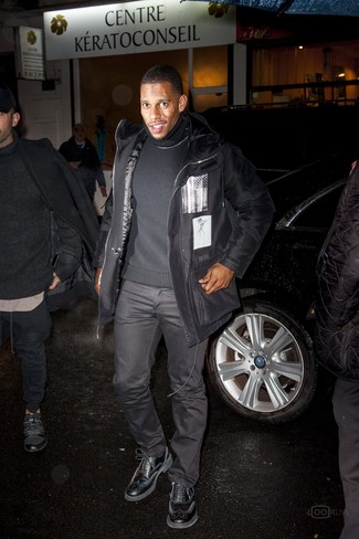 Victor Cruz wearing Black Parka, Black Turtleneck, Charcoal Chinos, Black Leather Brogues