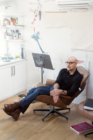 Stanley Tucci wearing Black Polo Neck Sweater, Navy Jeans, Brown Leather Casual Boots, Red Socks