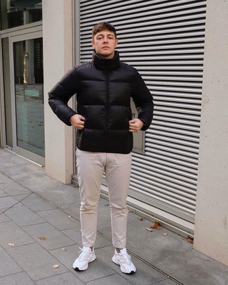 Black Puffer Jacket Outfits For Men: You'll be amazed at how easy it is for any man to get dressed this way. Just a black puffer jacket paired with beige chinos. Go ahead and introduce white athletic shoes to the equation for a bit more edginess.