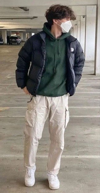 Dark Green Hoodie Outfits For Men: Wear a dark green hoodie with beige cargo pants for relaxed dressing with an edgy finish. White leather low top sneakers will pull the whole thing together.