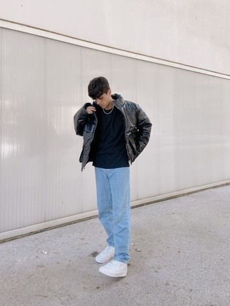 500+ Chill Weather Outfits For Men: Go for a simple yet refined choice in a black leather puffer jacket and light blue jeans. If you wish to easily dress down your getup with shoes, make white leather low top sneakers your footwear choice.