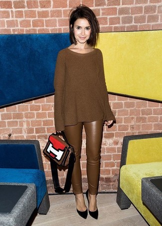 Miroslava Duma wearing Multi colored Leather Satchel Bag, Black Suede Pumps, Brown Leather Skinny Pants, Brown Knit Oversized Sweater