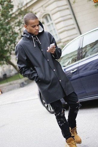 Black Raincoat Outfits For Men: For a cool and casual ensemble, reach for a black raincoat and black ripped jeans — these items fit beautifully together. Complement this ensemble with tan leather work boots to inject a hint of stylish nonchalance into your outfit.