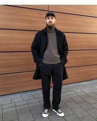 Black Raincoat Outfits For Men: Effortlessly blurring the line between dapper and laid-back, this combo of a black raincoat and black chinos can easily become one of your go-tos. If not sure as to what to wear in the shoe department, stick to black and white canvas low top sneakers.