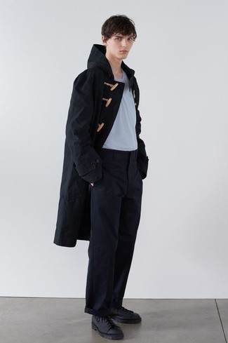 Black Raincoat Outfits For Men: Effortlessly blurring the line between dapper and casual, this pairing of a black raincoat and navy chinos will easily become your favorite. For extra style points, introduce black leather low top sneakers to the mix.