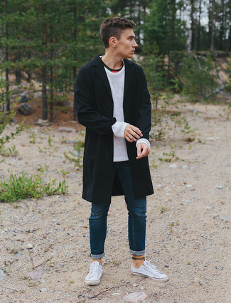 Black Raincoat Outfits For Men: Swing into something casual yet current with a black raincoat and navy jeans. A pair of white canvas low top sneakers integrates smoothly within a myriad of ensembles.