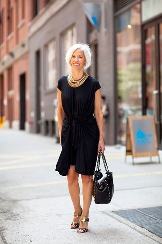Wear a black sheath dress if you're aiming for a neat, chic look. We're totally digging how complete this outfit looks when completed with black and gold leather heeled sandals.