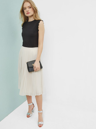 Beige Pleated Midi Skirt Outfits: For an outfit that's super simple but can be flaunted in many different ways, rock a black sleeveless top with a beige pleated midi skirt. For something more on the elegant end to finish this look, go for silver leather heeled sandals.