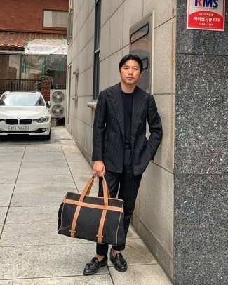 Black Canvas Tote Bag Outfits For Men: A black vertical striped suit and a black canvas tote bag will give off this casual and cool vibe. Feeling adventerous today? Polish up your ensemble by sporting a pair of black leather tassel loafers.