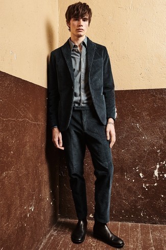 To look like a stylish gentleman, dress in a black corduroy suit and a grey dress shirt. Take an otherwise all-too-safe look a more laid-back path with dark brown leather chelsea boots.