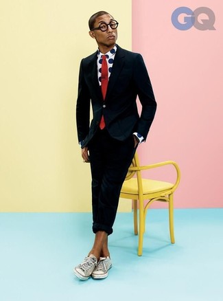 Pharrell Williams wearing Black Suit, White and Navy Polka Dot Long Sleeve Shirt, White Canvas Low Top Sneakers, Red Tie