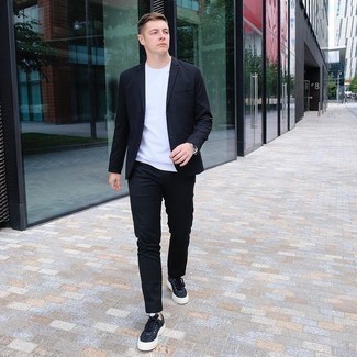Black Suit Outfits: A black suit and a white crew-neck t-shirt? This outfit will make heads turn. To bring out a more easy-going side of you, complete this getup with a pair of black canvas low top sneakers.