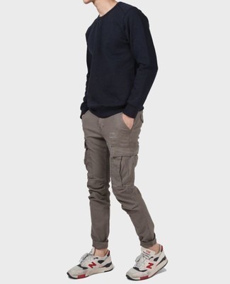 Black Sweatshirt Outfits For Men: Why not consider wearing a black sweatshirt and grey cargo pants? Both of these pieces are totally functional and will look good when worn together. You can get a little creative on the shoe front and complement this ensemble with grey athletic shoes.