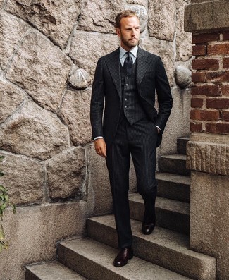 Black Vertical Striped Wool Three Piece Suit Outfits: Combining a black vertical striped wool three piece suit and a white dress shirt is a fail-safe way to infuse your styling routine with some masculine elegance. Burgundy leather oxford shoes look perfectly at home here.