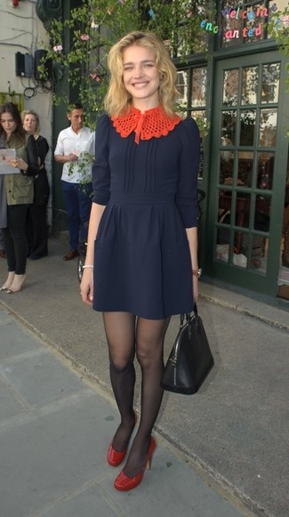 Natalia Vodianova wearing Black Tights, Black Leather Tote Bag, Red Leather Pumps, Navy Fit and Flare Dress