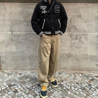 Black Canvas Fanny Pack Outfits For Men: Choose a black print varsity jacket and a black canvas fanny pack for a modern twist on casual street ensembles. You can take a classic approach with shoes and complement your outfit with a pair of navy canvas low top sneakers.