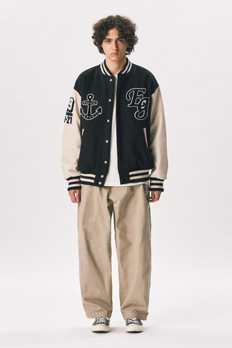 Charcoal Canvas Low Top Sneakers Outfits For Men: A black print varsity jacket and khaki chinos? It's easily a wearable look that you can work on a daily basis. For extra fashion points, add a pair of charcoal canvas low top sneakers to this ensemble.