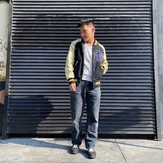 Black Canvas Low Top Sneakers Outfits For Men: A black print varsity jacket and navy jeans are a savvy combo worth integrating into your daily casual arsenal. Complete your ensemble with black canvas low top sneakers to pull the whole thing together.