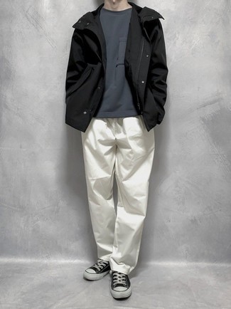 Black Windbreaker Outfits For Men: Dapper yet practical, this look is comprised of a black windbreaker and white chinos. If not sure about the footwear, go with a pair of black and white canvas low top sneakers.