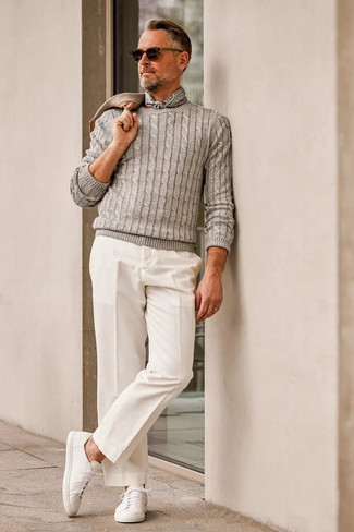 Charcoal Cable Sweater Outfits For Men: Consider teaming a charcoal cable sweater with white chinos for an everyday getup that's full of style and personality. Wondering how to round off? Introduce white canvas low top sneakers to your ensemble to shake things up.