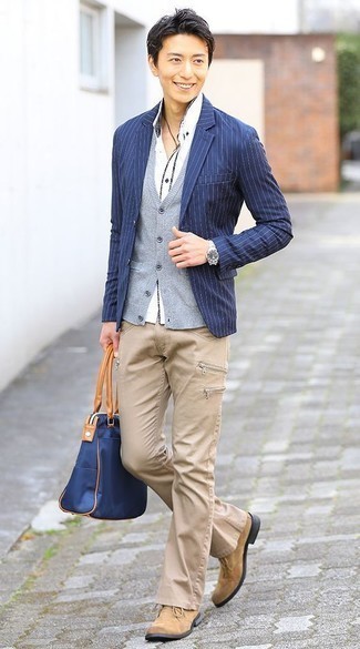 Blue Vertical Striped Blazer Outfits For Men: This combination of a blue vertical striped blazer and khaki jeans is a safe bet for an utterly cool ensemble. Tan suede desert boots are a welcome addition for your getup.