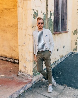 White Blazer Outfits For Men: Channel your inner fashionisto and pair a white blazer with olive chinos. For something more on the relaxed side to finish this look, complement this outfit with a pair of white canvas low top sneakers.