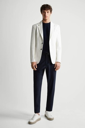 White Blazer Outfits For Men: Marrying a white blazer and navy chinos is a surefire way to inject your daily repertoire with some masculine refinement. You know how to tone it down: white canvas low top sneakers.