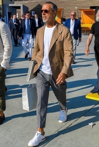 White Leather Zip Pouch Outfits For Men: This casual street style pairing of a tan blazer and a white leather zip pouch is very versatile and really up for whatever's on your to-do list today. A pair of white canvas low top sneakers easily elevates any ensemble.