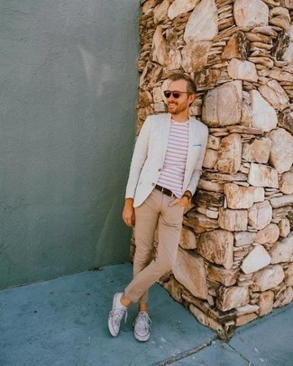 White Jacket Outfits For Men: As you can see here, looking dapper doesn't take that much time. Just make a white jacket and khaki jeans your outfit choice and you'll look incredibly stylish. Look at how well this ensemble is completed with a pair of white canvas low top sneakers.