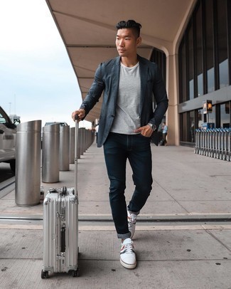 White Print Canvas Low Top Sneakers Outfits For Men: Pair a navy blazer with navy jeans to be the picture of rugged sophistication. To bring out a more laid-back side of you, complement your ensemble with a pair of white print canvas low top sneakers.