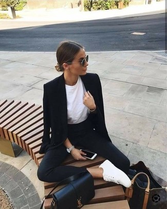 Black Blazer Outfits For Women: If you're a fan of classic combos, then you'll appreciate this pairing of a black blazer and black skinny pants. A cool pair of white leather low top sneakers is the most effective way to bring a dash of casualness to your ensemble.